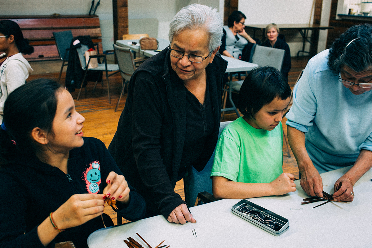 Eleanor Stephenson helps her granddaughters with their crafts.