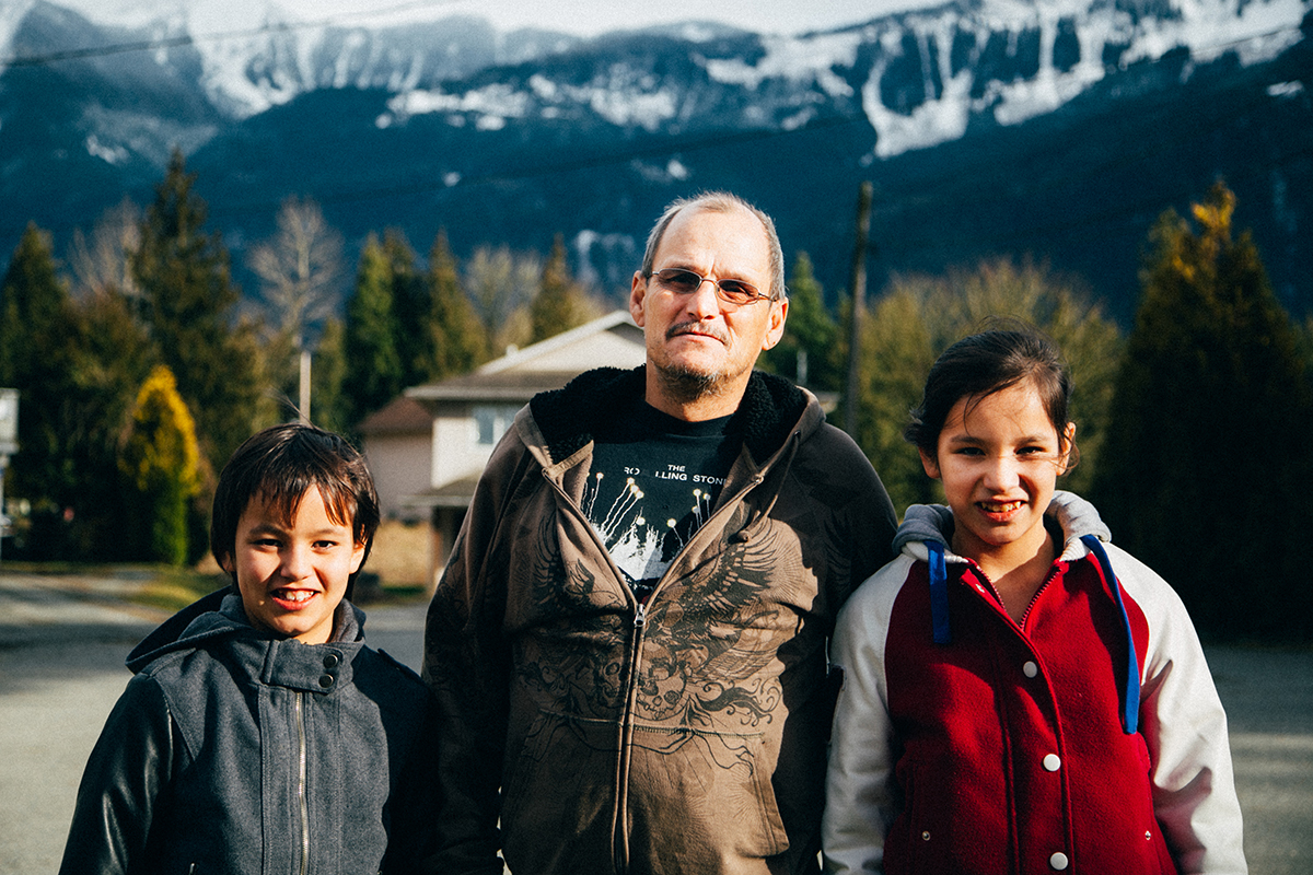 Myron Douglas stands proudly with his two daughters.