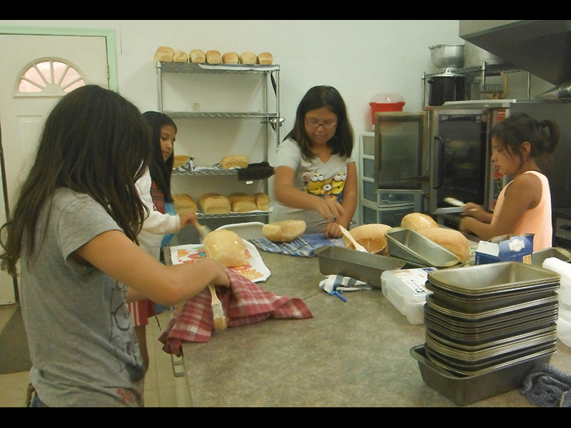 Natural Changes campers learn to bake bread and make jam in the Charlie Longhouse kitchen. Photo courtesy of James Leon.